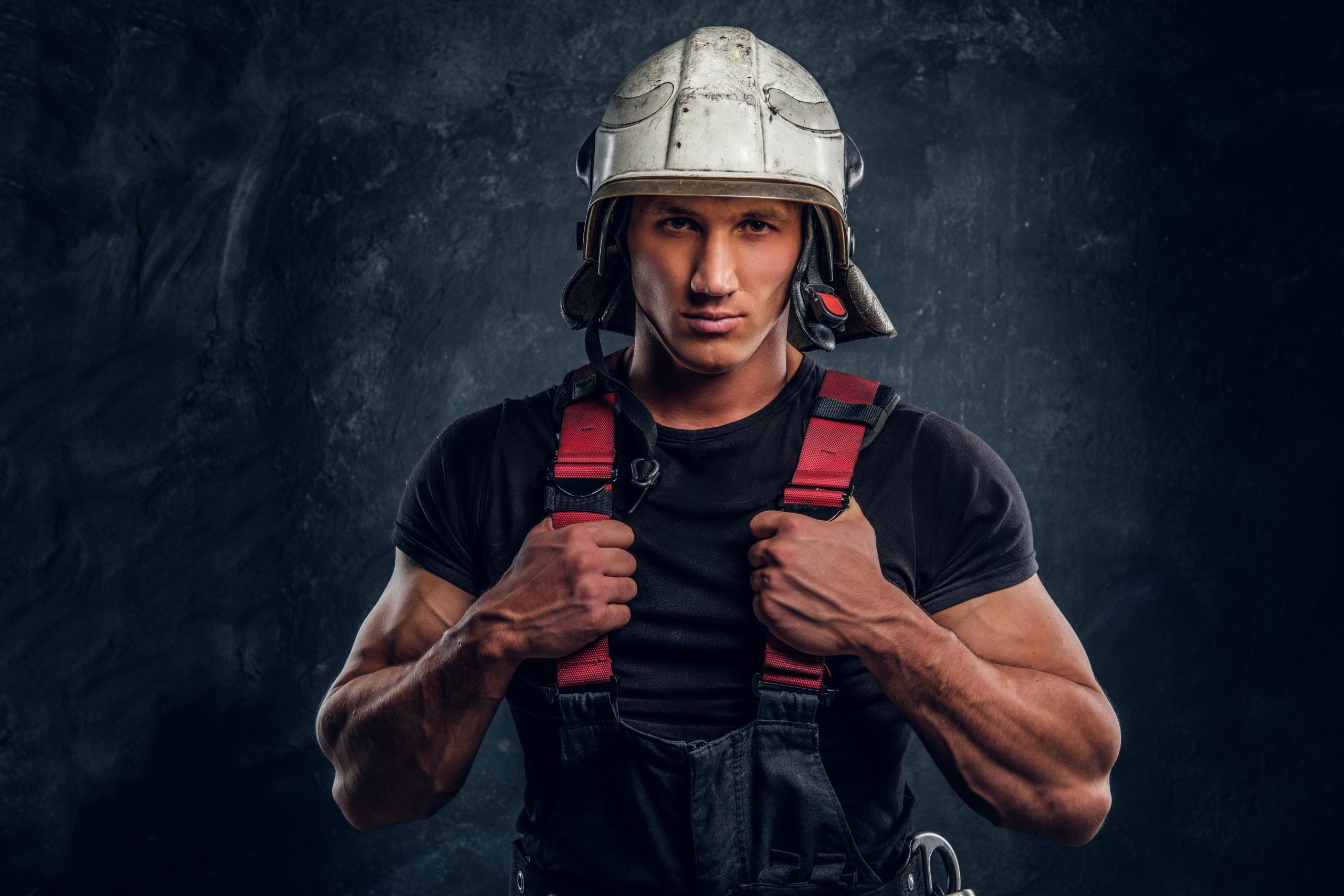 studio portrait handsome man wearing fire helmet gloves looking camera (1)